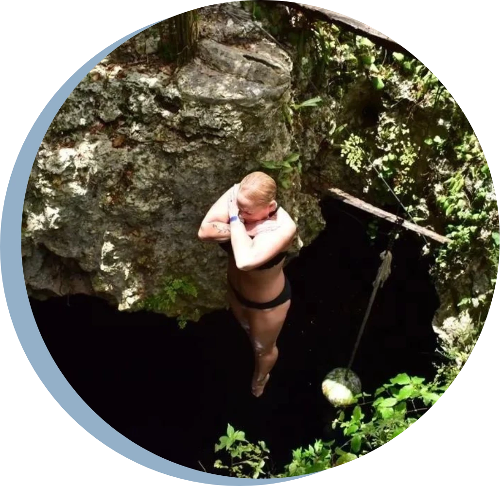 A man is hanging from the side of a cliff.
