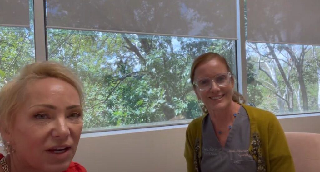 Two woman looking at the camera and smiling