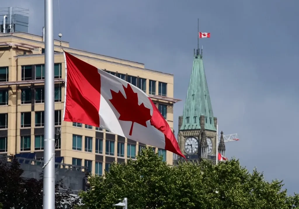 The flag of Canada waving on a pole