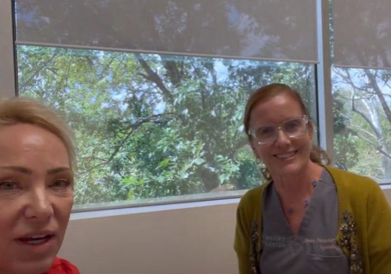 Two woman looking at the camera and smiling